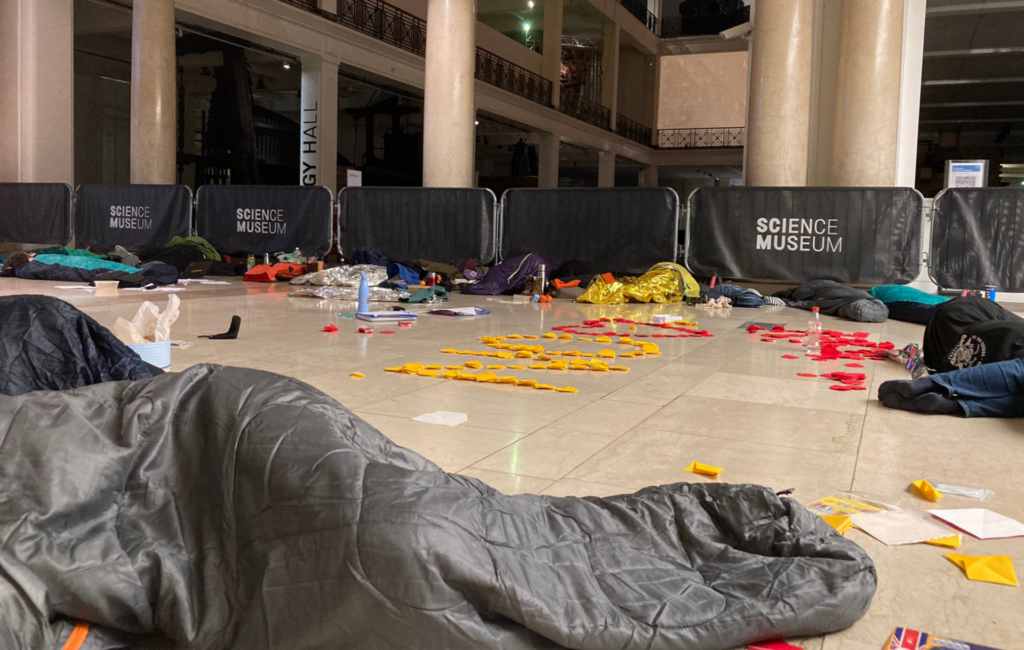 Student activists in sleeping bags inside the Science Museum