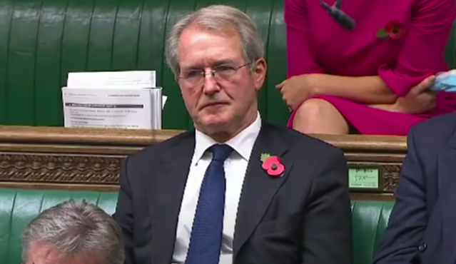 Owen Paterson sitting in the Commons