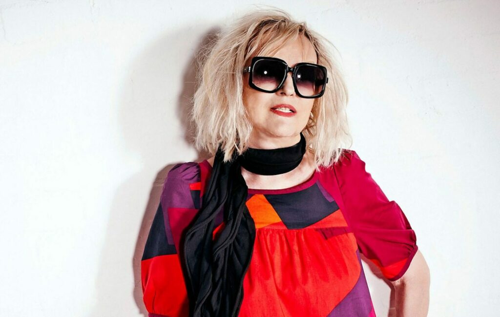 Annie Nightingale wearing sunglasses against a white background