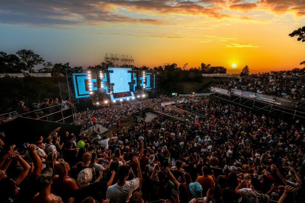 Aerial view of a busy festival stage at dusk