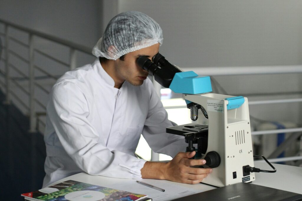 A doctor looks through a telescope