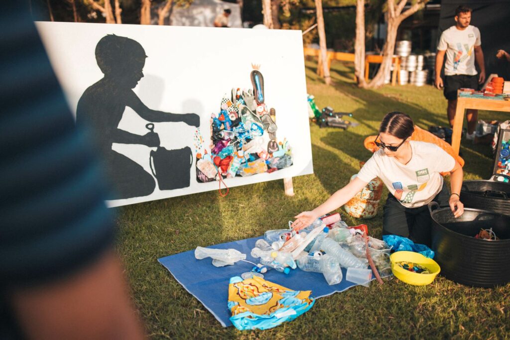 People sitting on the grass painting