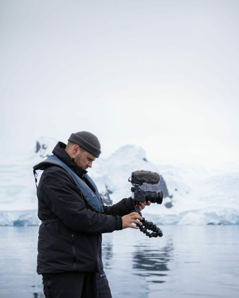 A man in a glacial envionment taking photos