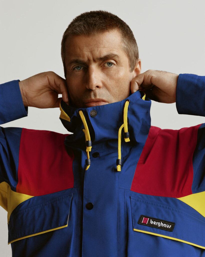 Liam Gallagher wears blue and red Berghaus jacket with yellow details