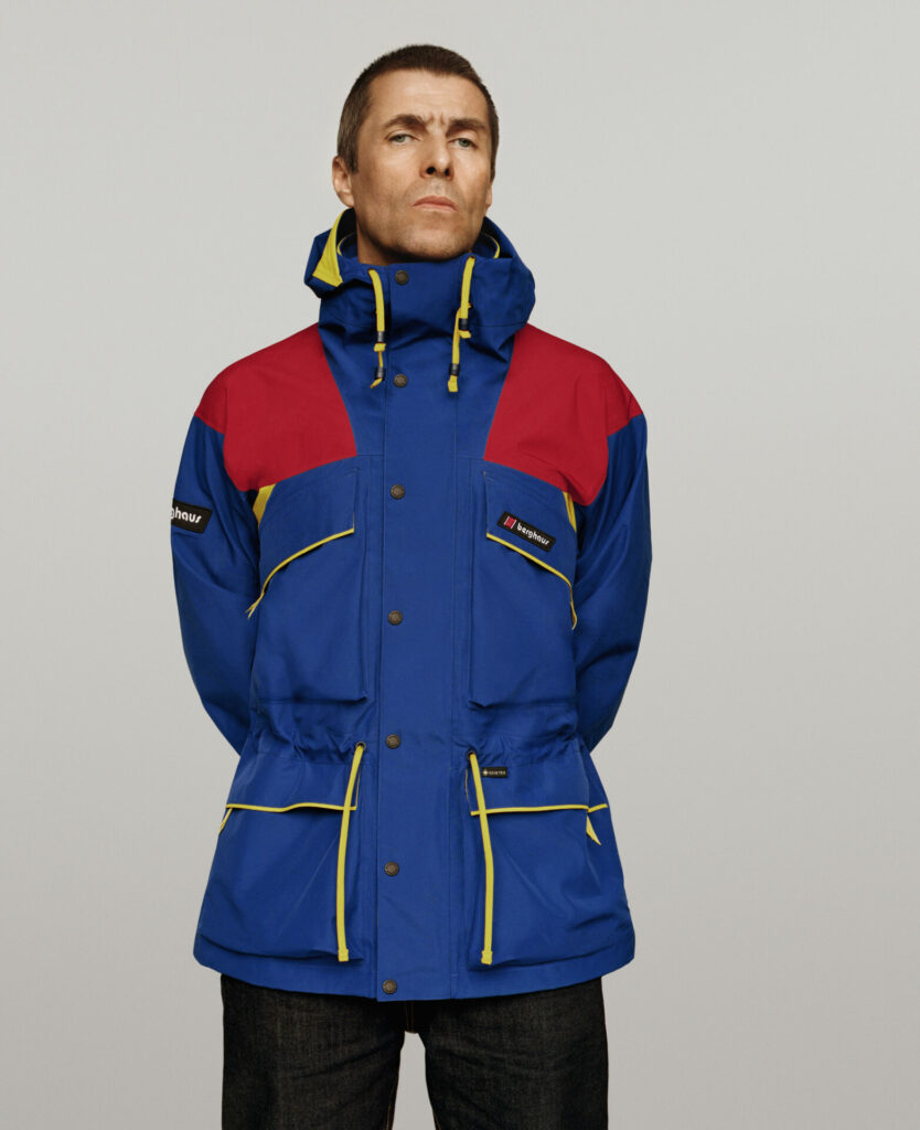 Liam Gallagher wears blue and red Berghaus jacket with yellow details