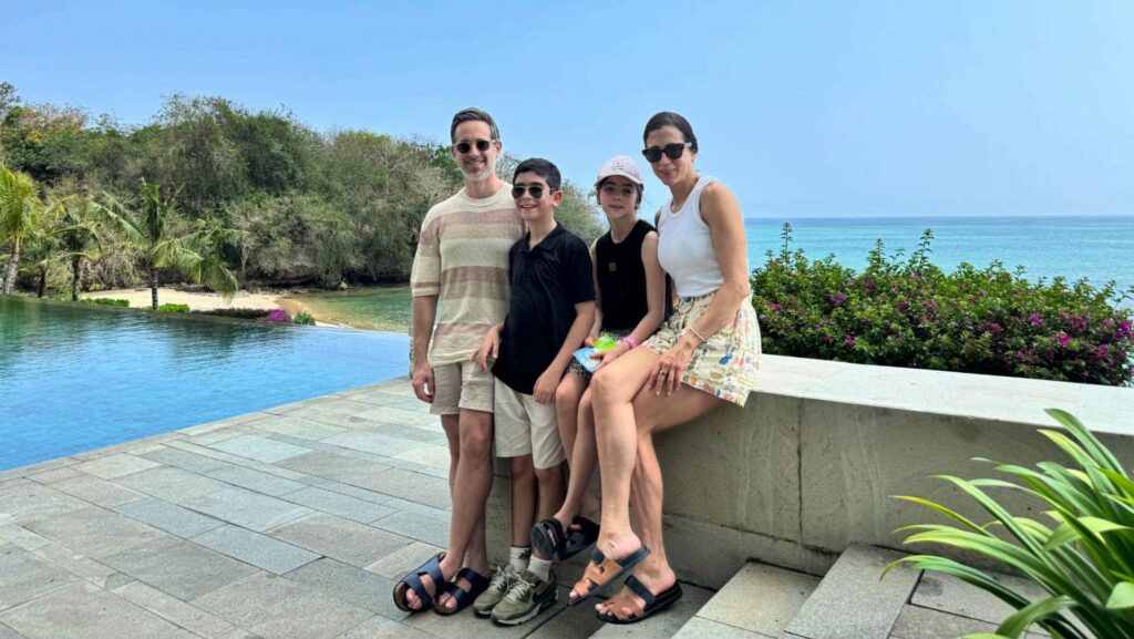 A family standing by a pool