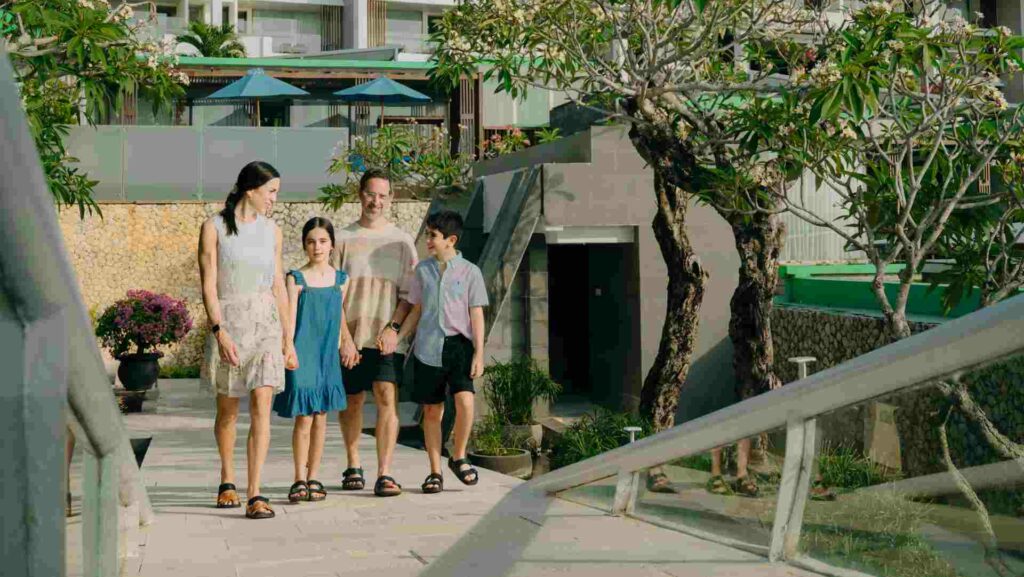 A family walking in a hotel's grounds