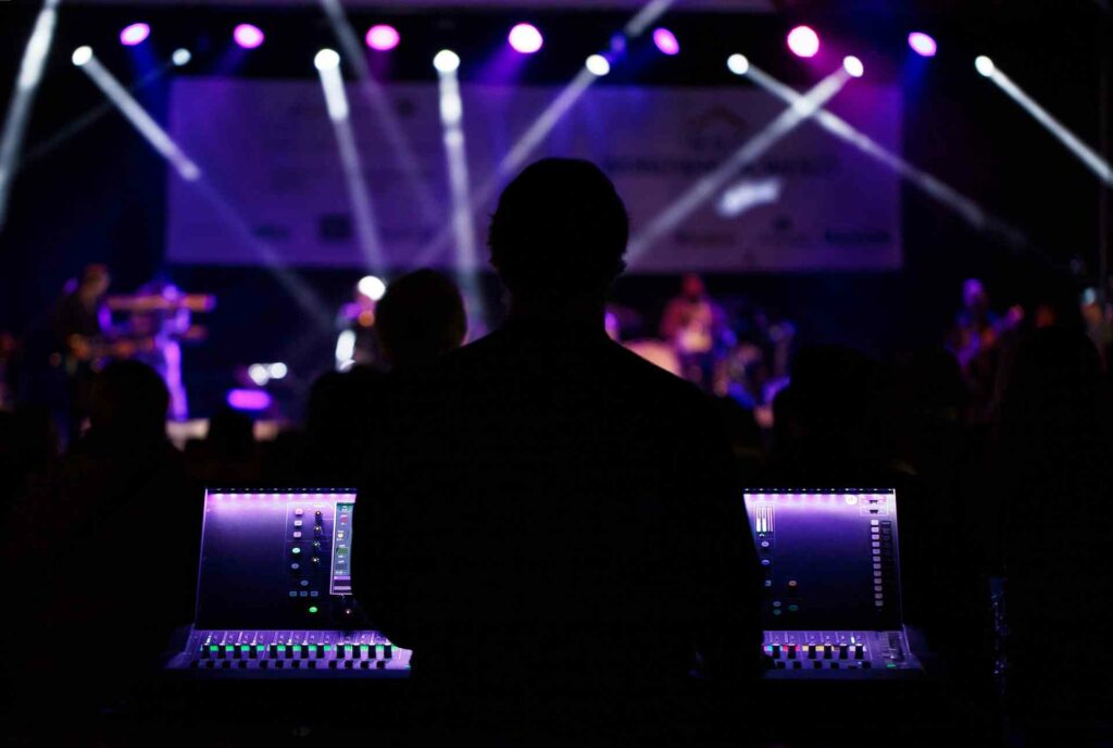 Rear shot of a DJ in a DJ booth