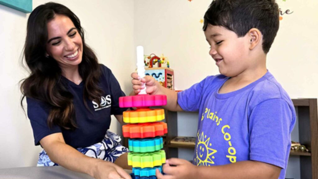 A woman and child playing with a toy