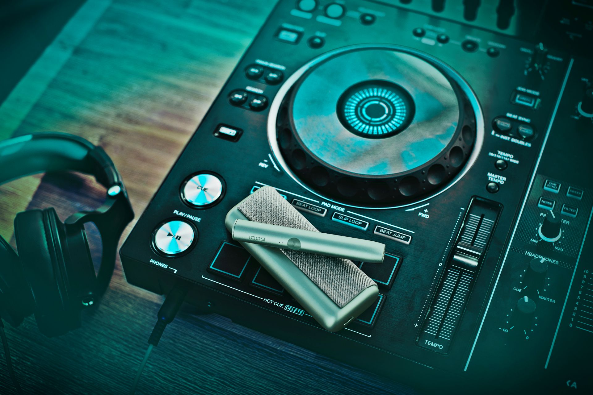 An IQOS device sitting on a DJ turntable