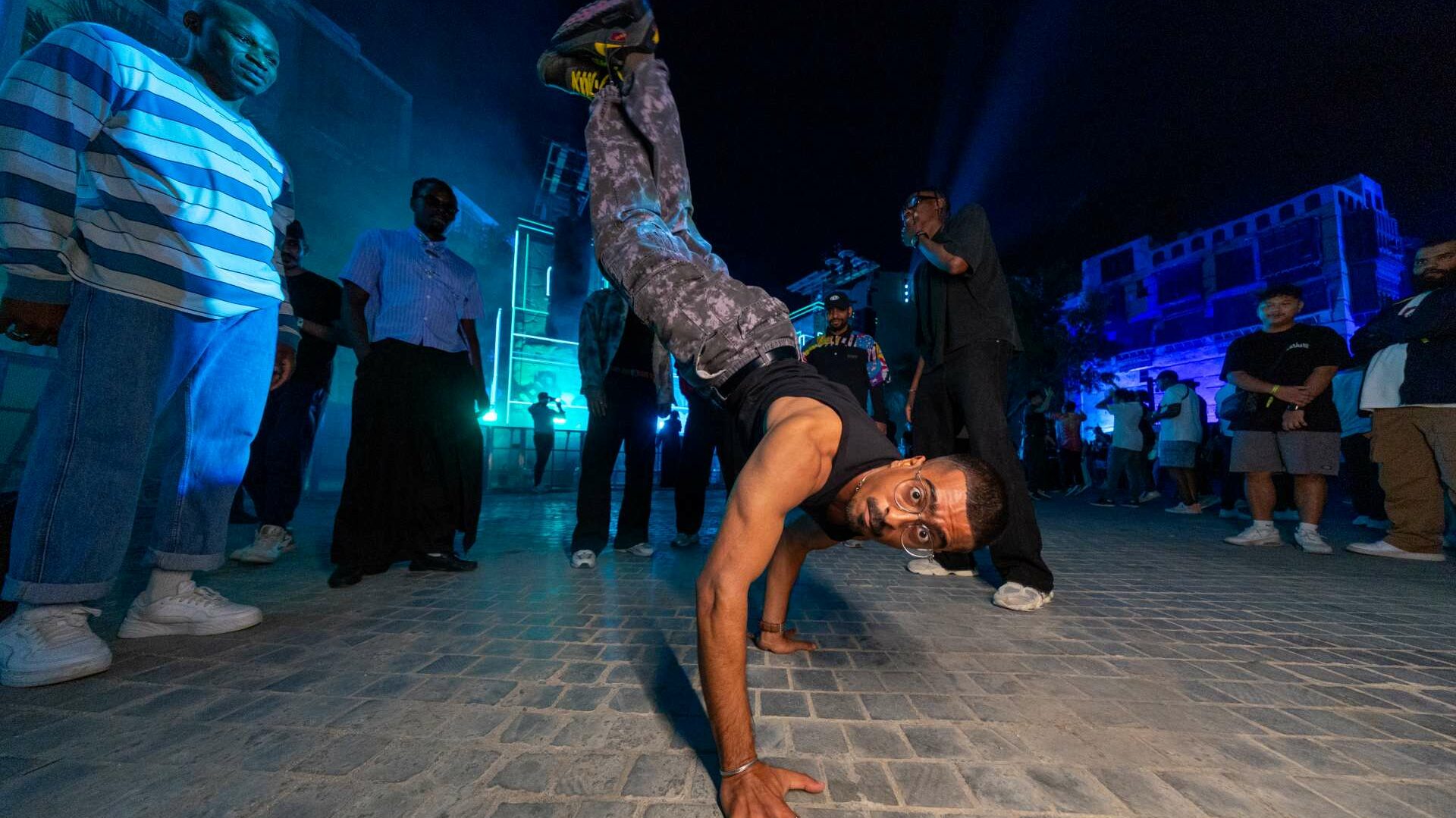 A man breakdances in front of a crowd at Balad Beast